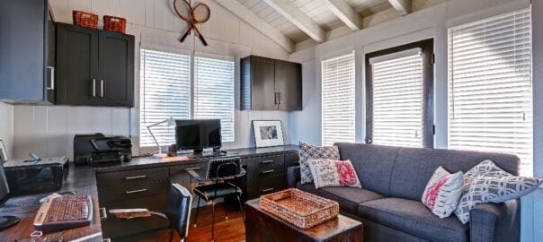 Porch space converted to home office with custom office cabinetry