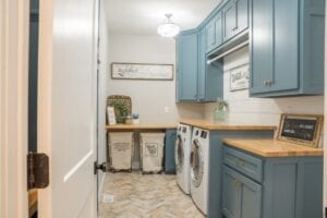 laundry room with blue cabinets