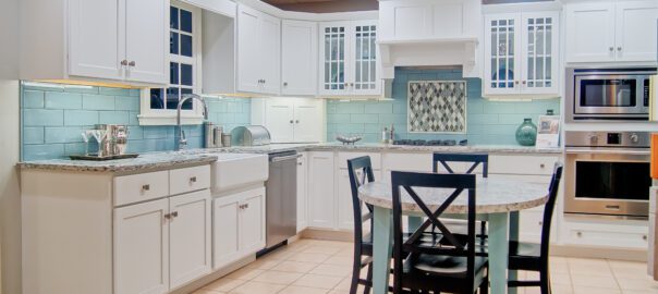 White farmhouse kitchen cabinets provide a bright, cheery atmosphere to a kitchen.