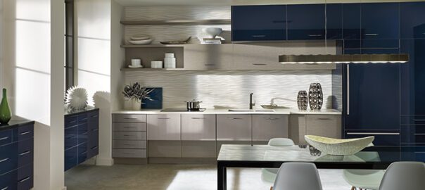 A mid-century modern kitchen with blue and gray cabinets and sleek furniture.
