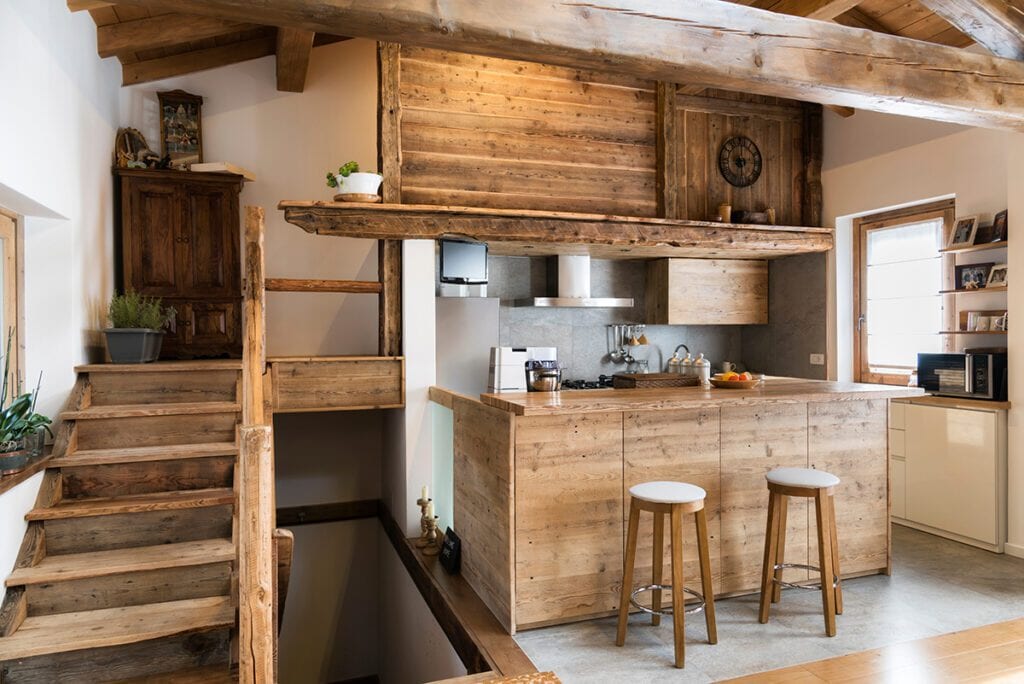 A small cottage kitchen with an antique wood island.