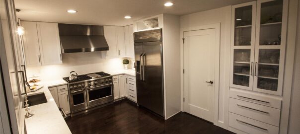 A modern kitchen with built-in cabinetry and stainless steel appliances